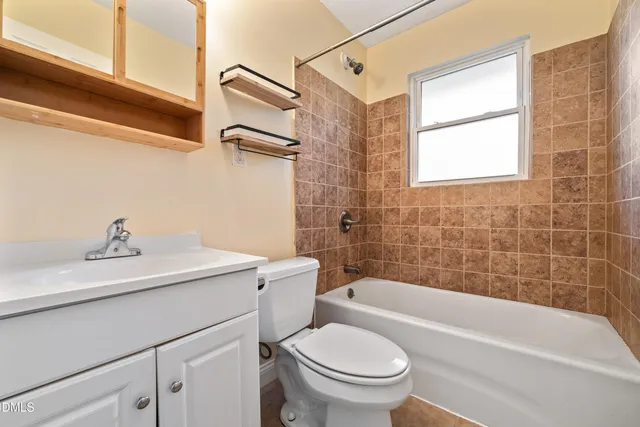 a bathroom with a sink a toilet and bathtub