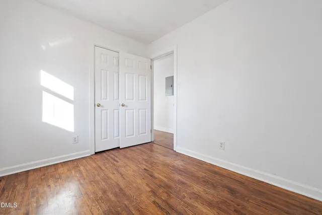 an empty room with wooden floor