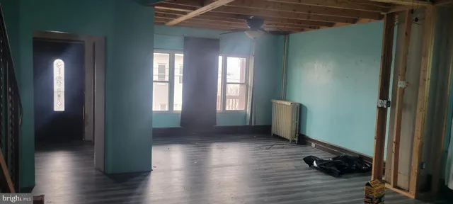 a room with wooden floor and windows