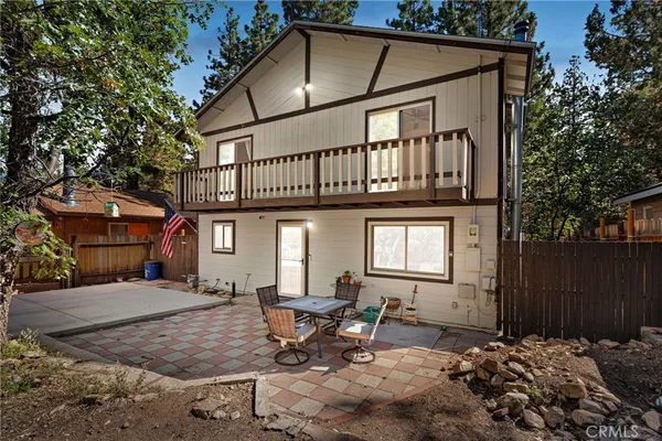 a backyard of a house with table and chairs
