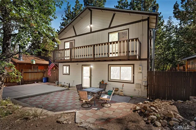 a backyard of a house with table and chairs