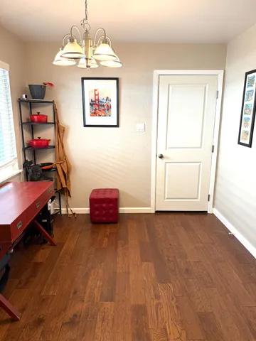 a view of a room with furniture and wooden floor