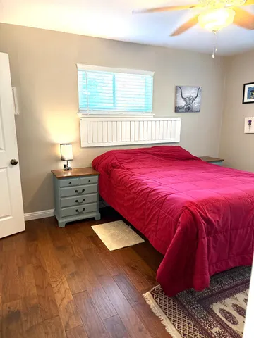 a bed sitting in a bedroom next to a window