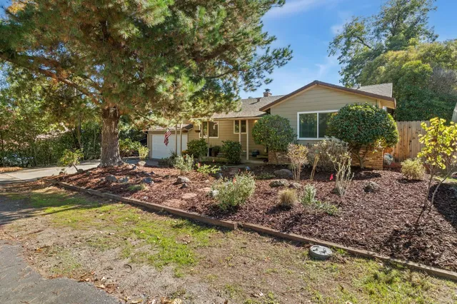 a view of a house with backyard and sitting area