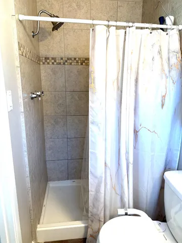 a bathroom with a toilet and shower