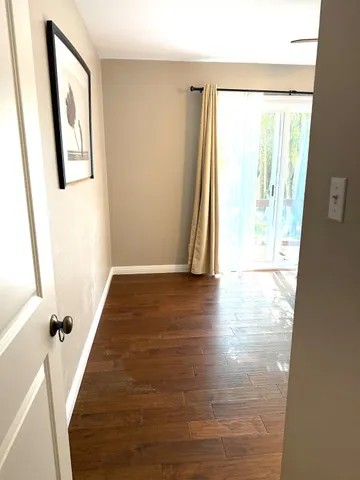 a view of a room with wooden floor and staircase