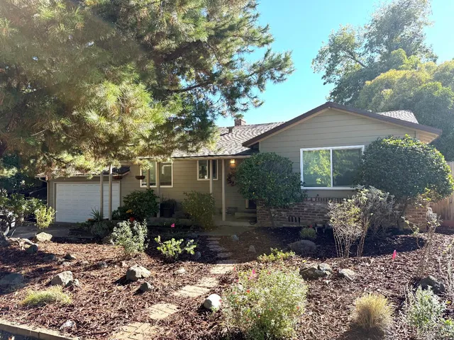 a front view of a house with a yard and outdoor seating