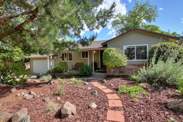 a view of a house with yard and sitting area