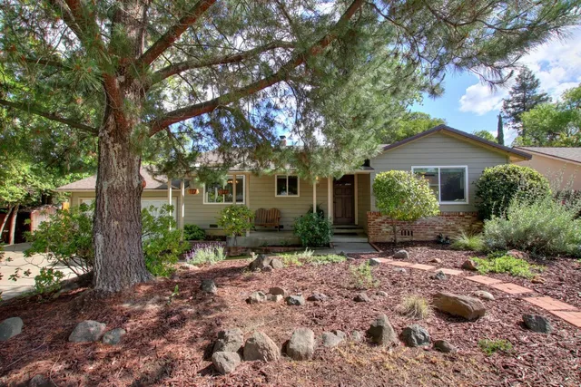 a front view of a house with a garden