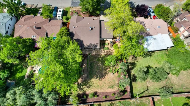 an aerial view of a house with a yard and garden