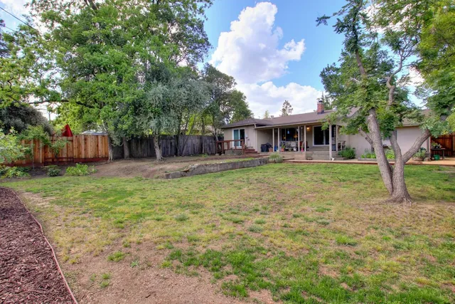 a front view of house with yard and trees