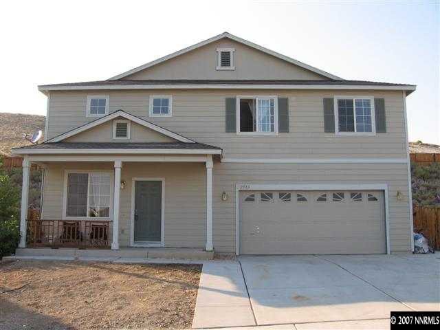 a front view of a house with garage