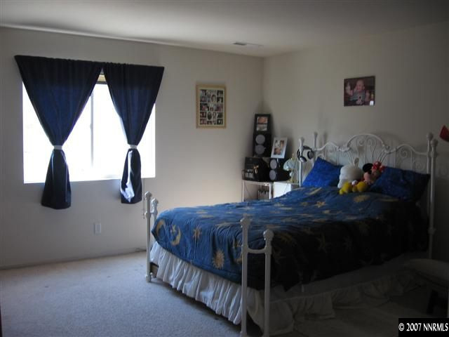 2585 Rio Rico Court Reno, NV 89523 - Photo 8 of 9 a bedroom with a bed and window