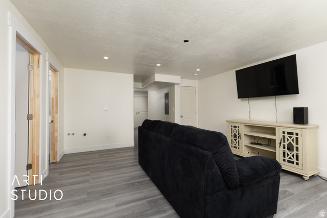 1713 South Windemere Road Santaquin, UT 84655 - Photo 25 of 40 Spacious room featuring light gray wood-finish flooring, recessed lighting, and crisp white walls