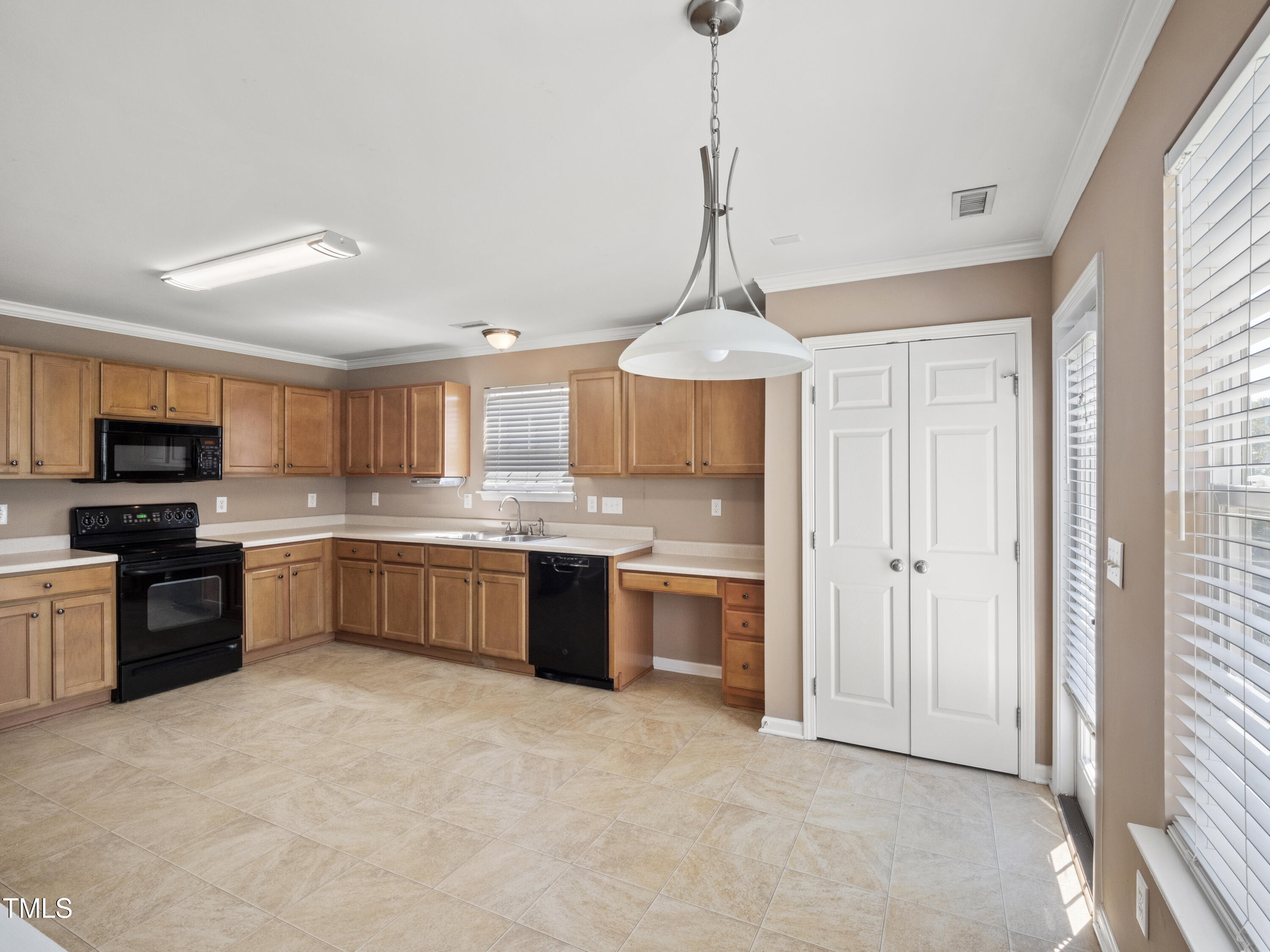 115 Geranium Street Durham, NC 27704 - Photo 16 of 47 a kitchen with stainless steel appliances granite countertop a stove top oven a sink and dishwasher