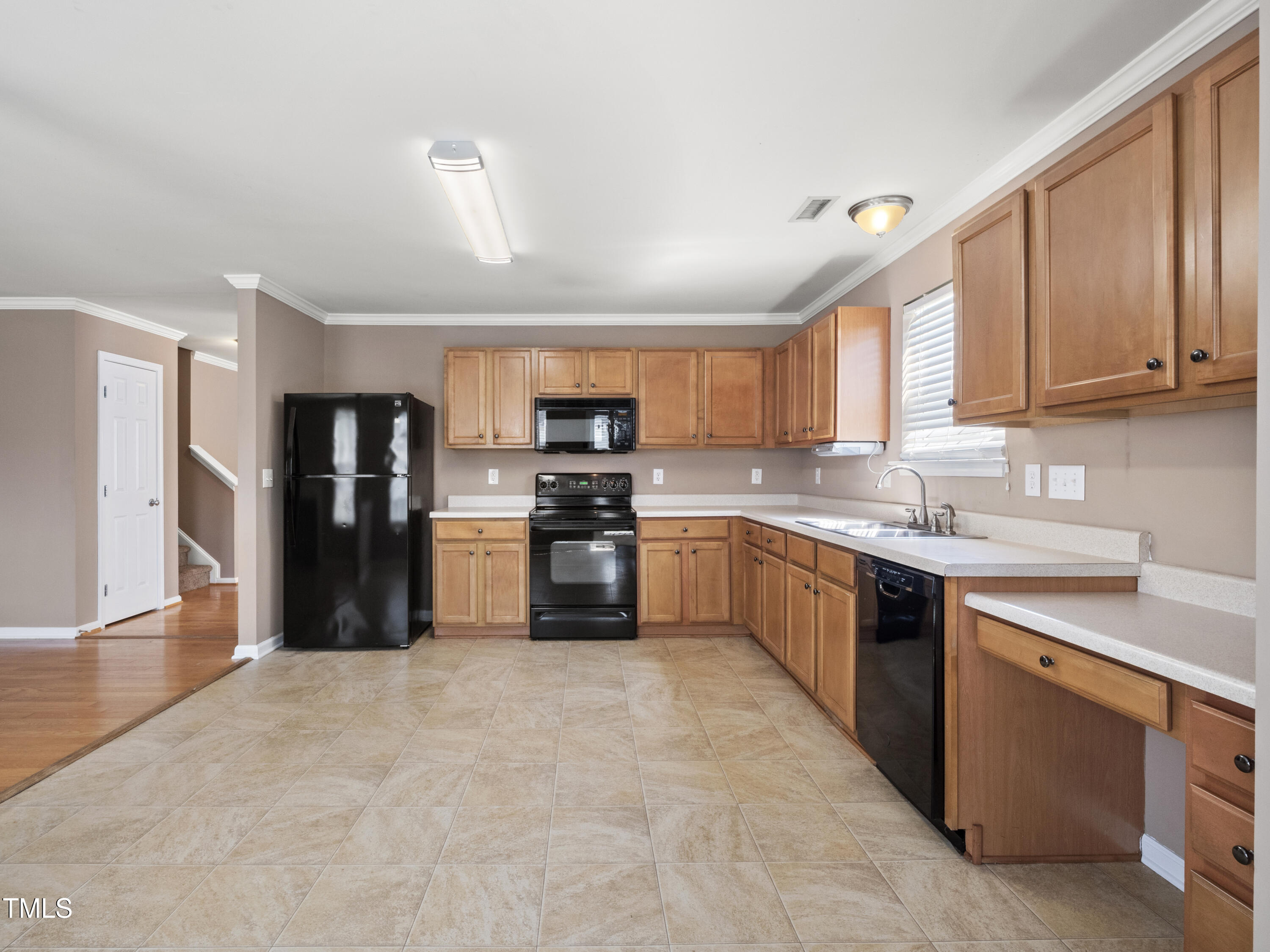 115 Geranium Street Durham, NC 27704 - Photo 17 of 47 a large kitchen with stainless steel appliances granite countertop a stove refrigerator sink and cabinets