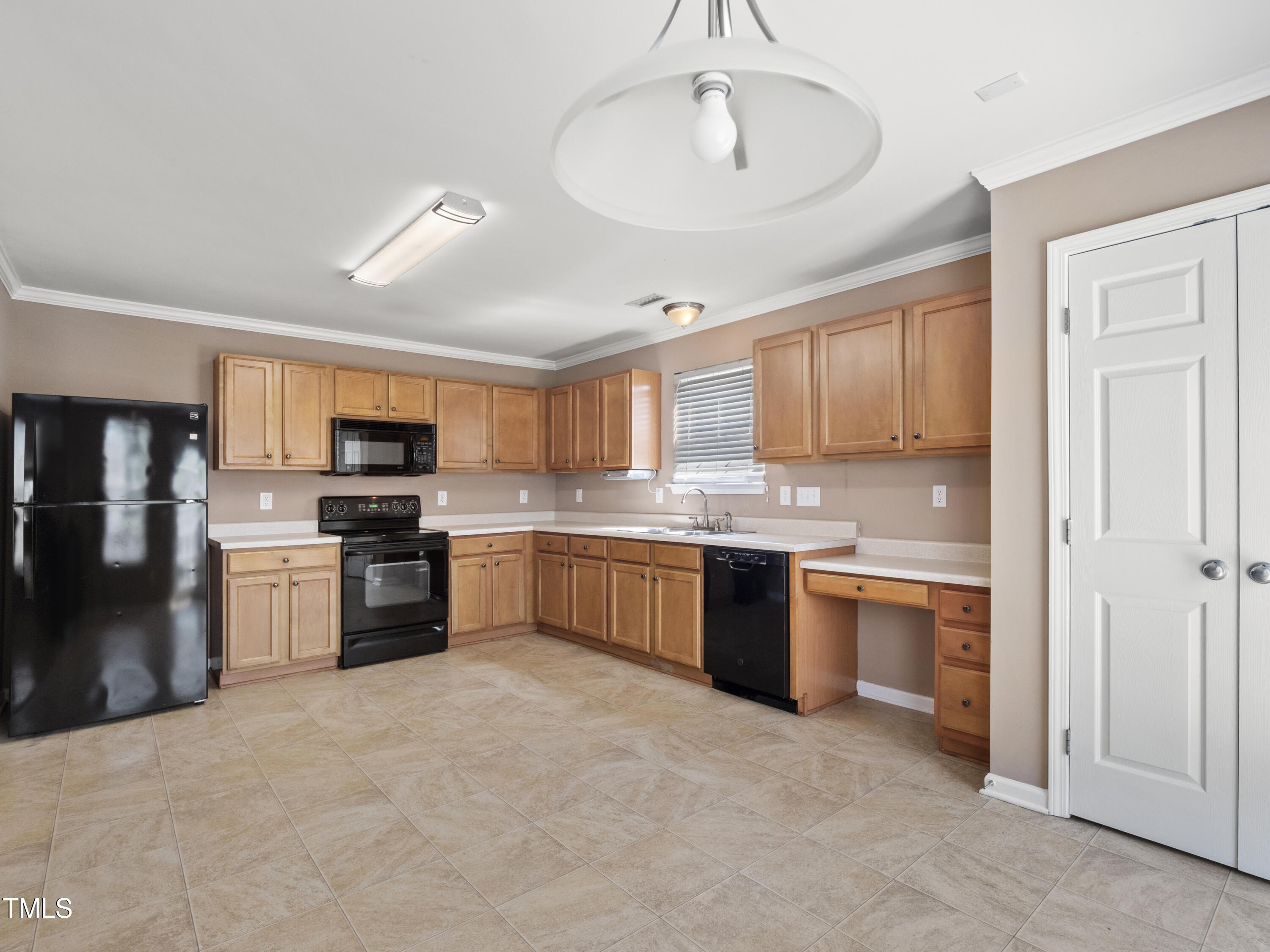 115 Geranium Street Durham, NC 27704 - Photo 18 of 47 a large kitchen with cabinets wooden floor and stainless steel appliances