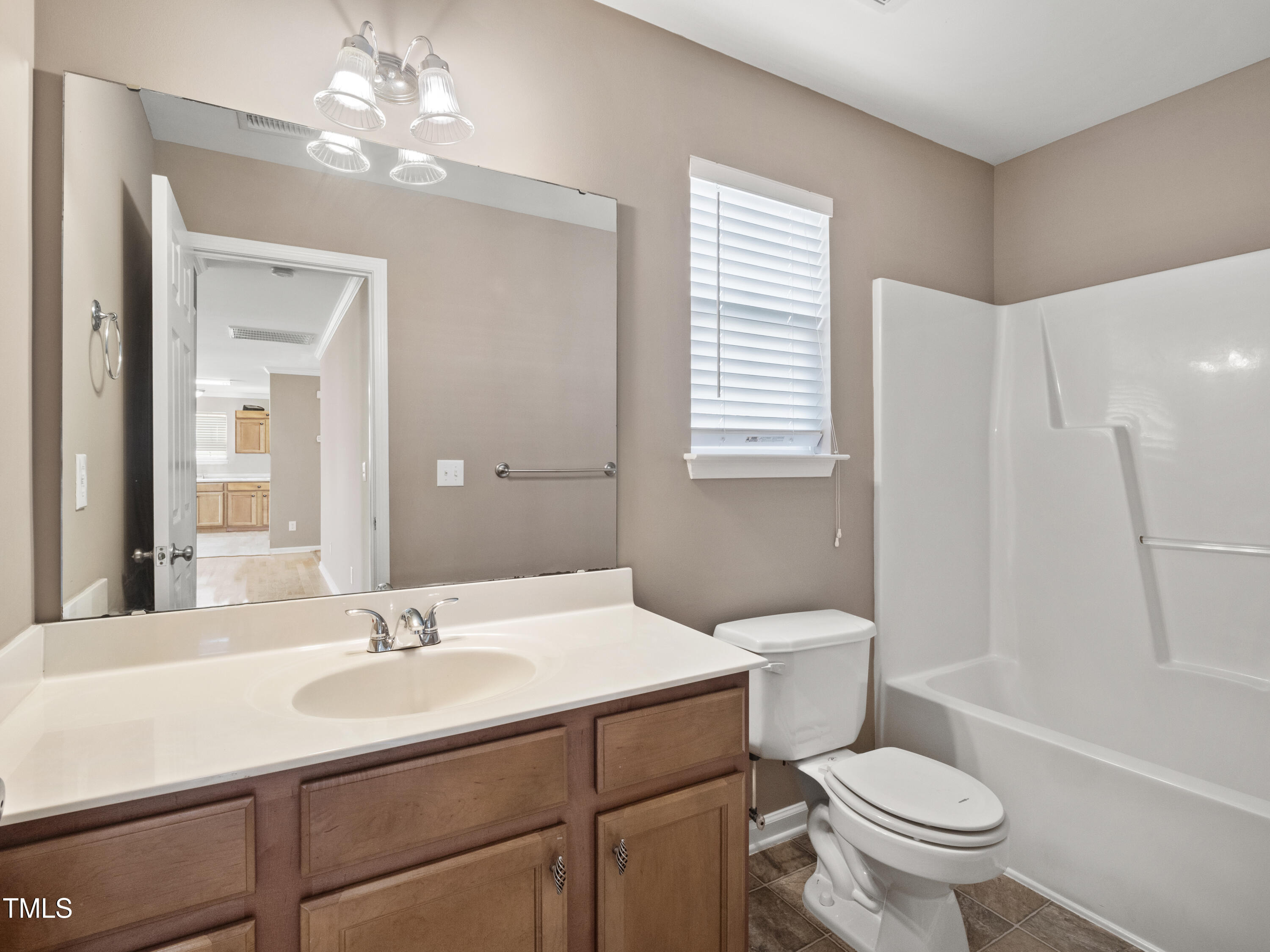 115 Geranium Street Durham, NC 27704 - Photo 21 of 47 a bathroom with a sink toilet a mirror and shower