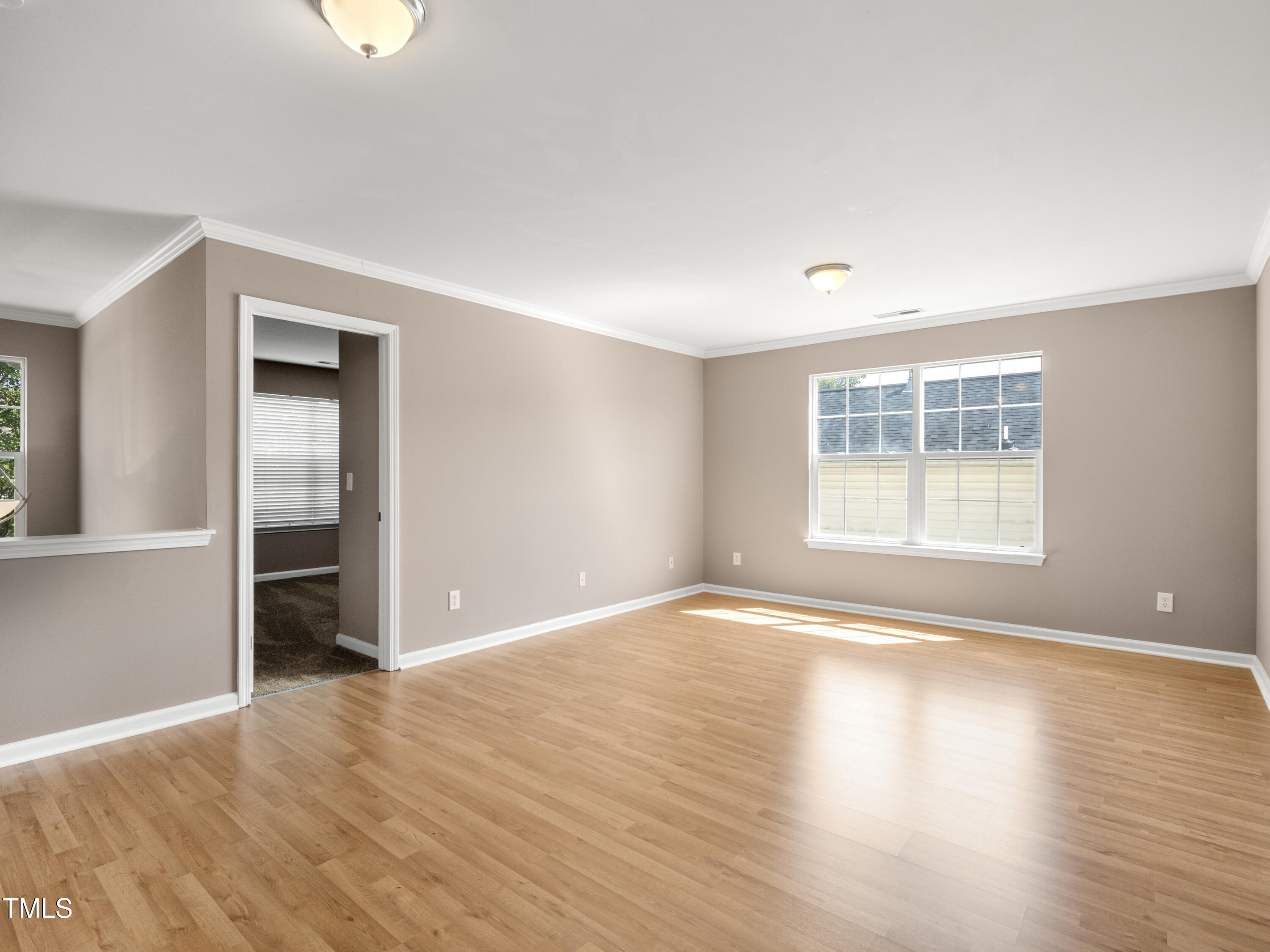 115 Geranium Street Durham, NC 27704 - Photo 25 of 47 an empty room with wooden floor and windows