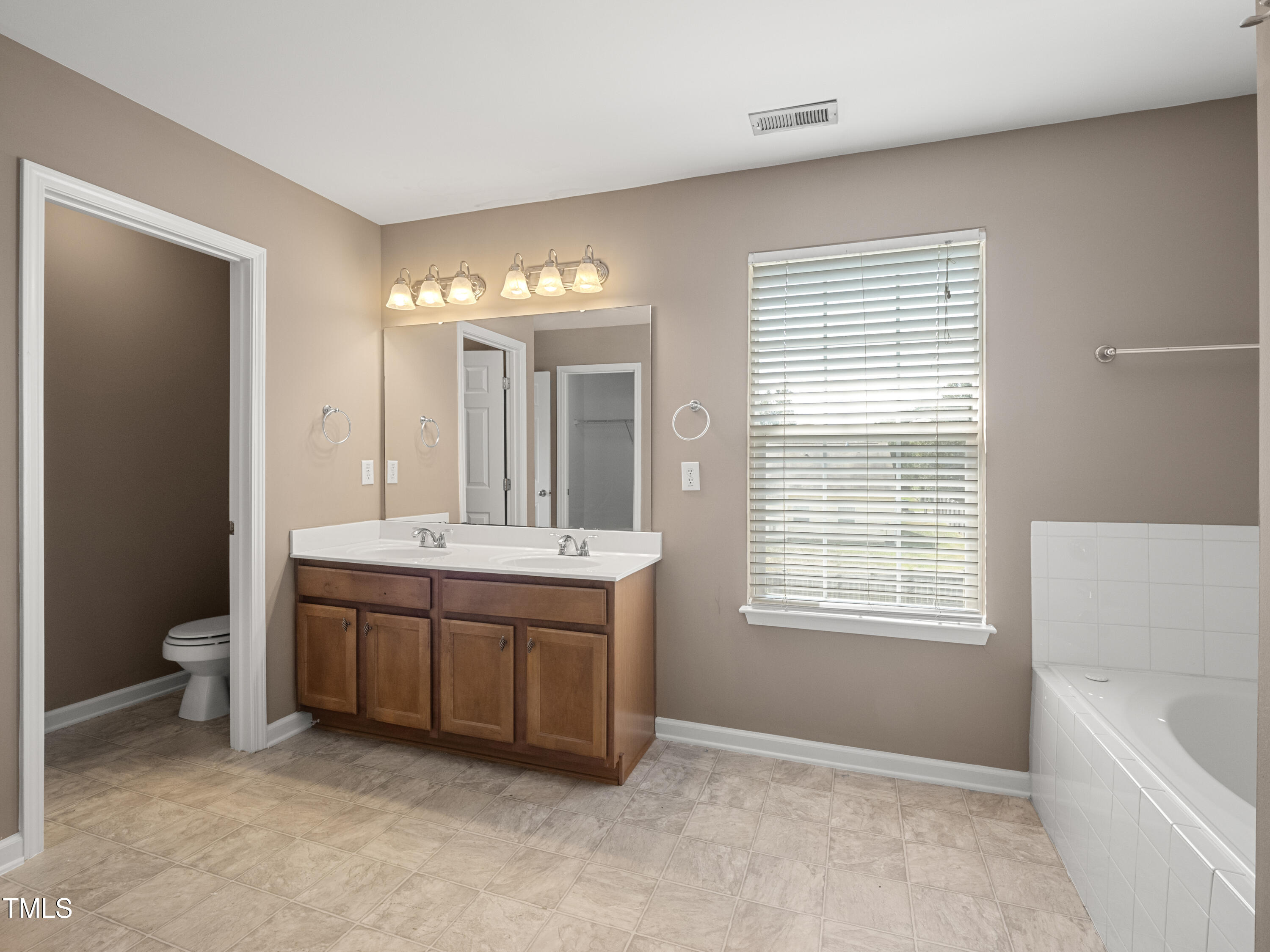 115 Geranium Street Durham, NC 27704 - Photo 44 of 47 a spacious bathroom with a granite countertop sink and a bathtub