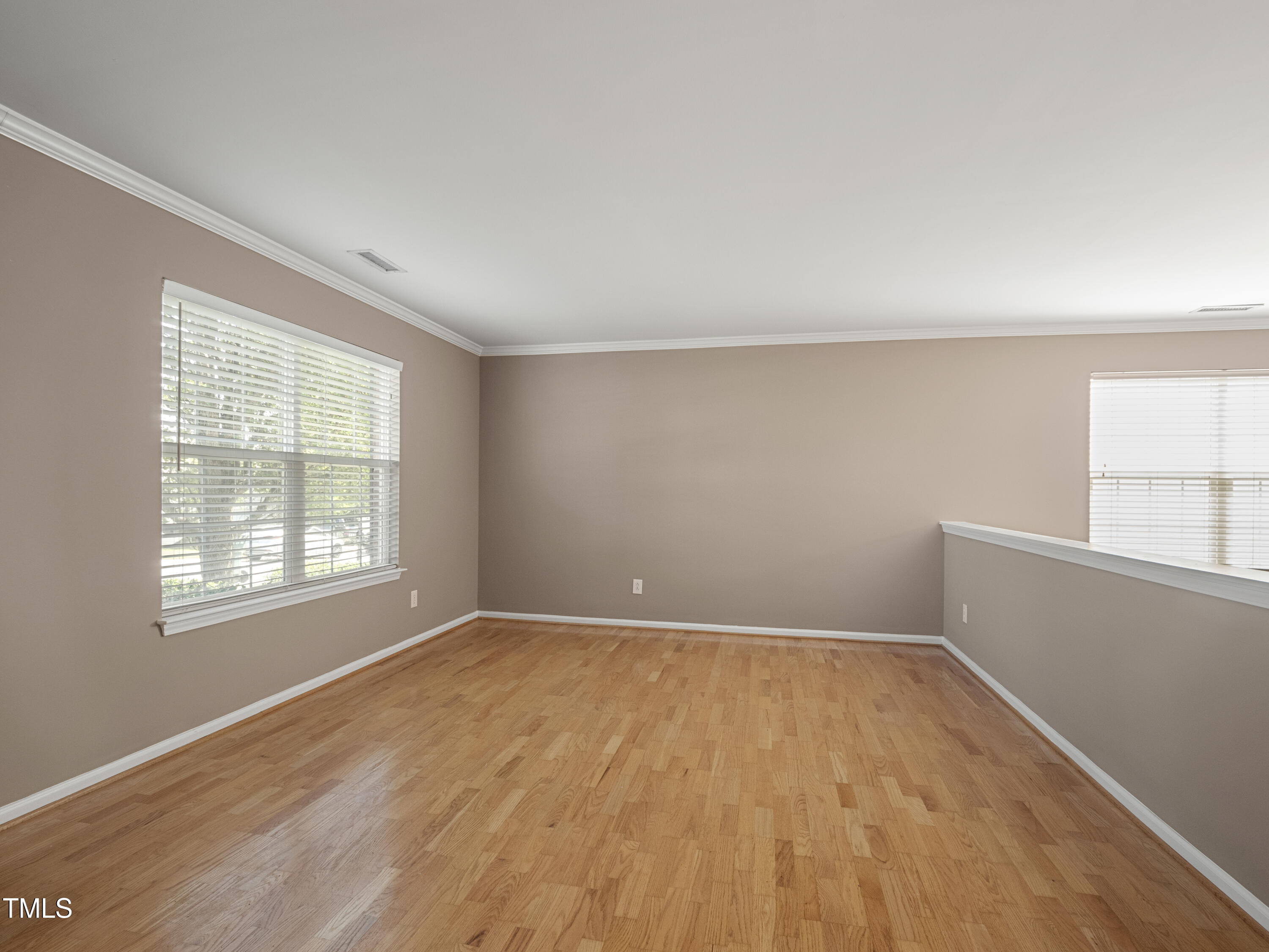 115 Geranium Street Durham, NC 27704 - Photo 6 of 47 an empty room with wooden floor and windows