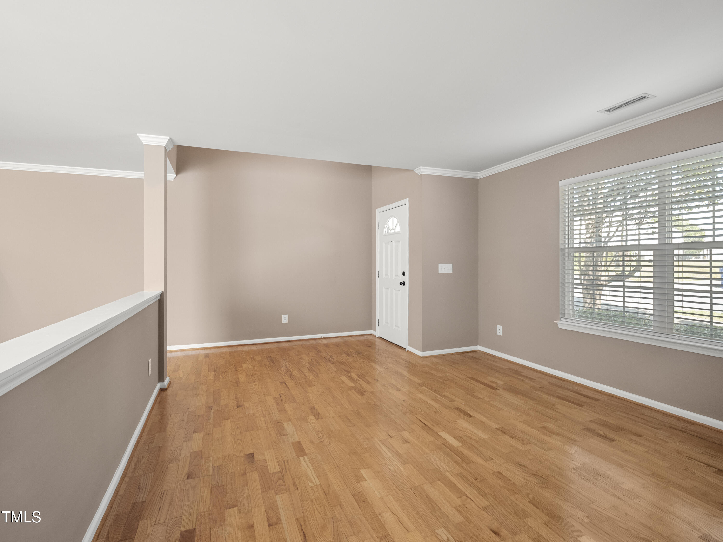 115 Geranium Street Durham, NC 27704 - Photo 10 of 47 a view of an empty room with wooden floor and a window