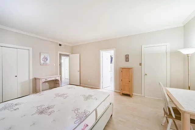 a bedroom with a bed and cabinets