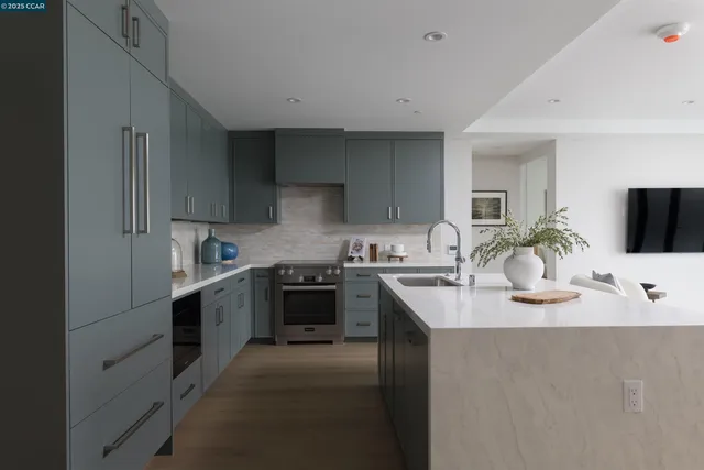 a kitchen with granite countertop a sink stove and cabinets