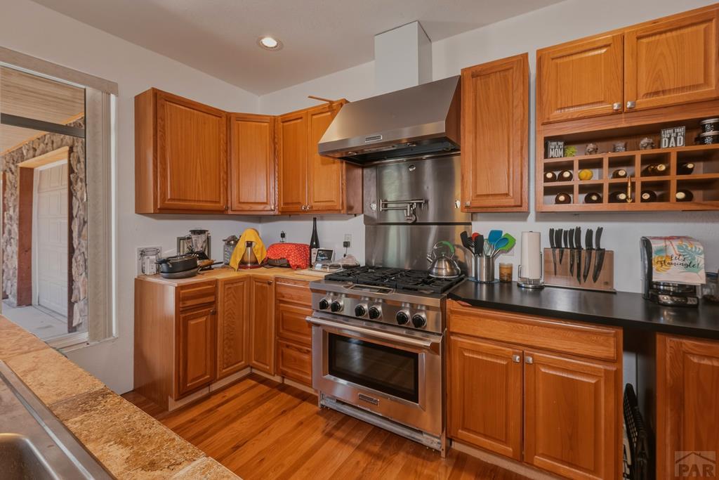 7880 Old Sopris Road Trinidad, CO 81082 - Photo 13 of 49 a kitchen with stainless steel appliances granite countertop a stove a sink and a microwave