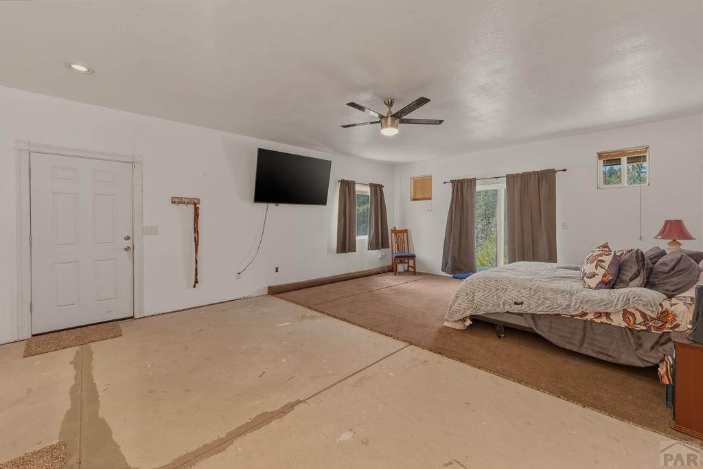 7880 Old Sopris Road Trinidad, CO 81082 - Photo 18 of 49 a spacious bedroom with a bed and a flat screen tv