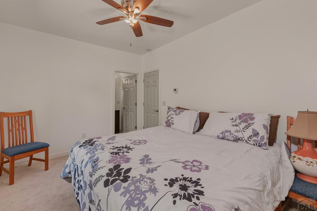 7880 Old Sopris Road Trinidad, CO 81082 - Photo 23 of 49 a bedroom with a bed and a chandelier