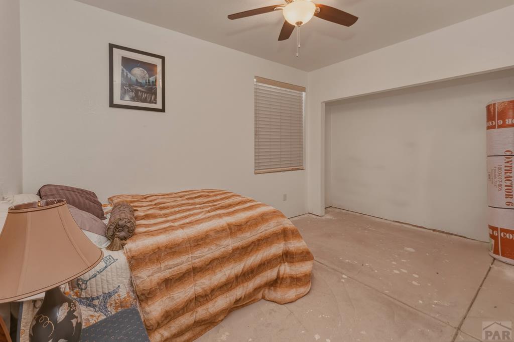 7880 Old Sopris Road Trinidad, CO 81082 - Photo 24 of 49 a bedroom with a bed and a chandelier