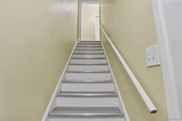 a view of a hallway with wooden floor and entryway