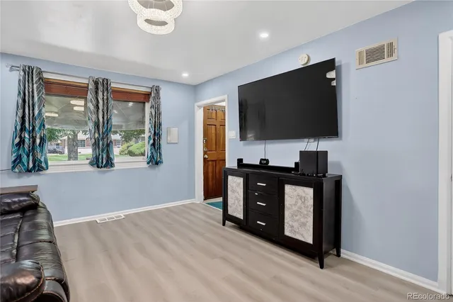 a kitchen with a refrigerator and a stove top oven