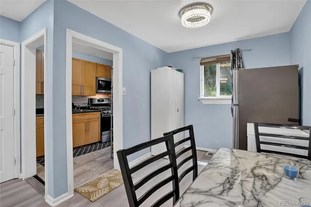 a kitchen with granite countertop a sink a stove and cabinets