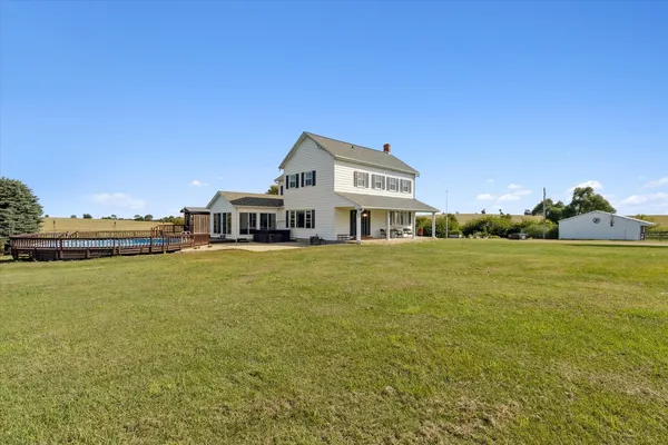a front view of a house with a big yard