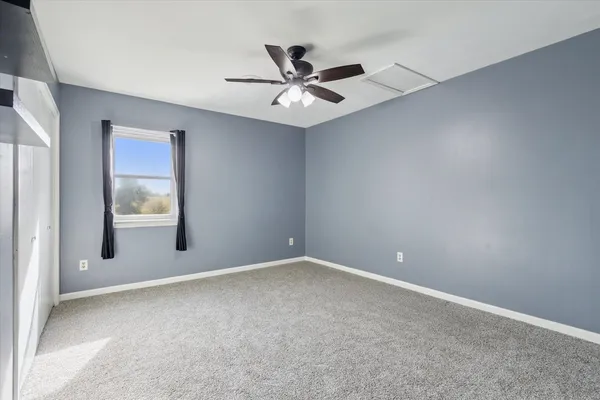 a living room with a fireplace windows and a fireplace