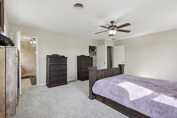 a living room with furniture and a ceiling fan