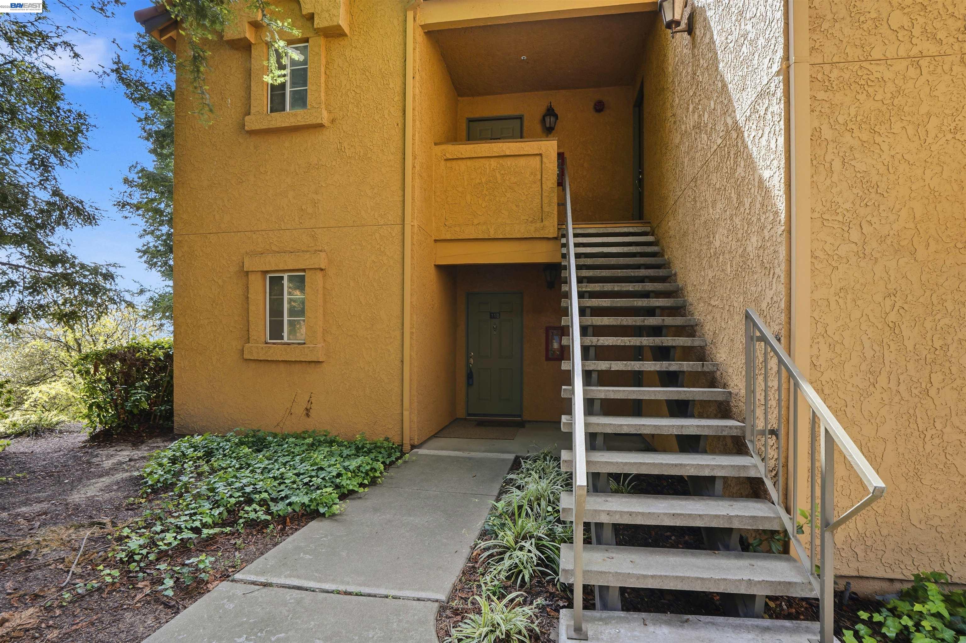 735 Watson Canyon Court, Unit 218 San Ramon, CA 94582 - Photo 14 of 18 a view of a pathway of a house with plants and wooden fence