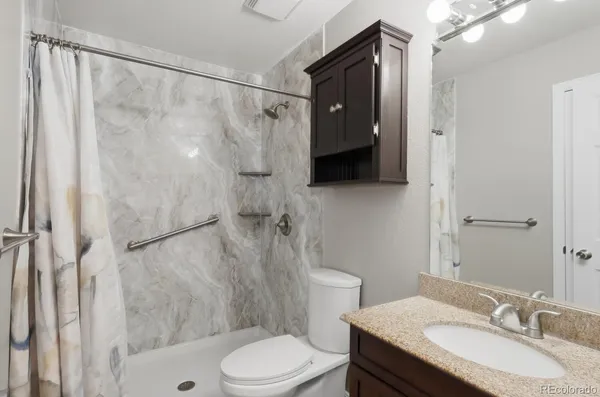 a bathroom with a sink toilet and shower