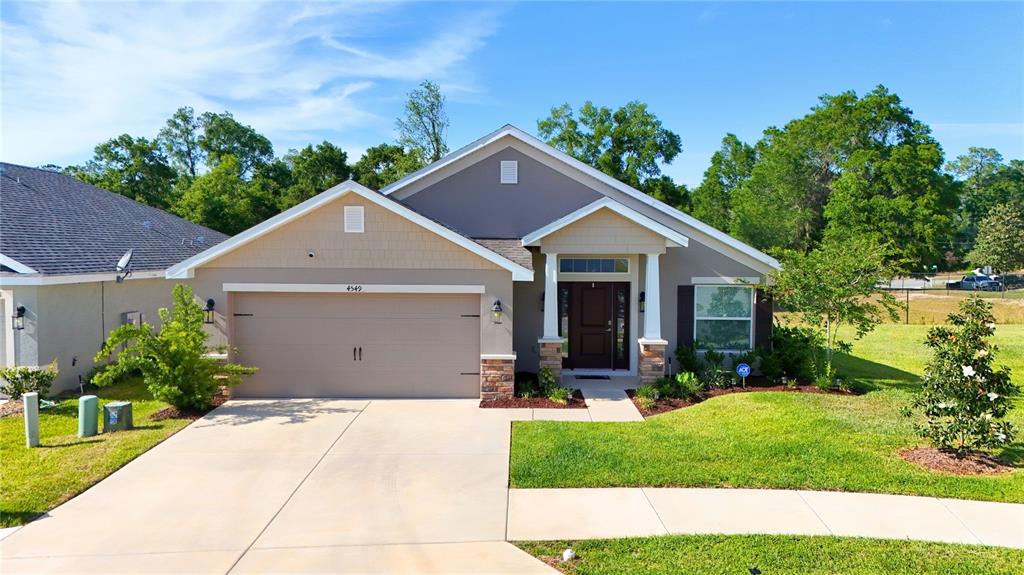 a front view of house with yard and green space