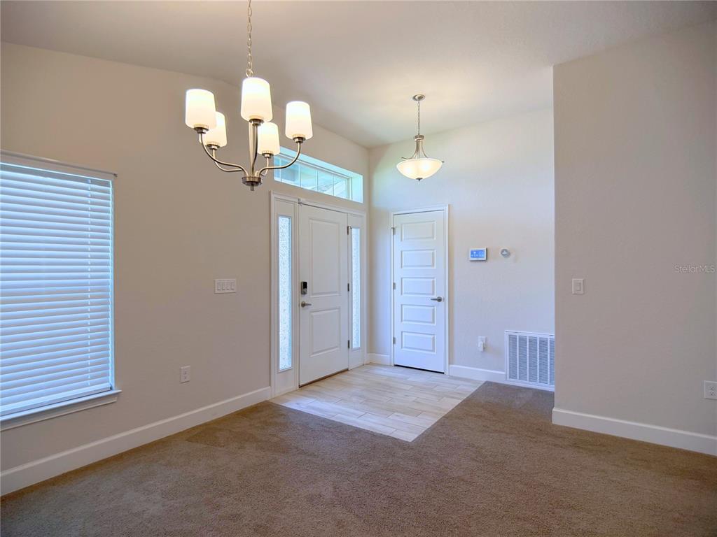 4549 Southeast 25th Loop Ocala, FL 34480 - Photo 4 of 25 an empty room with a mirror and a window