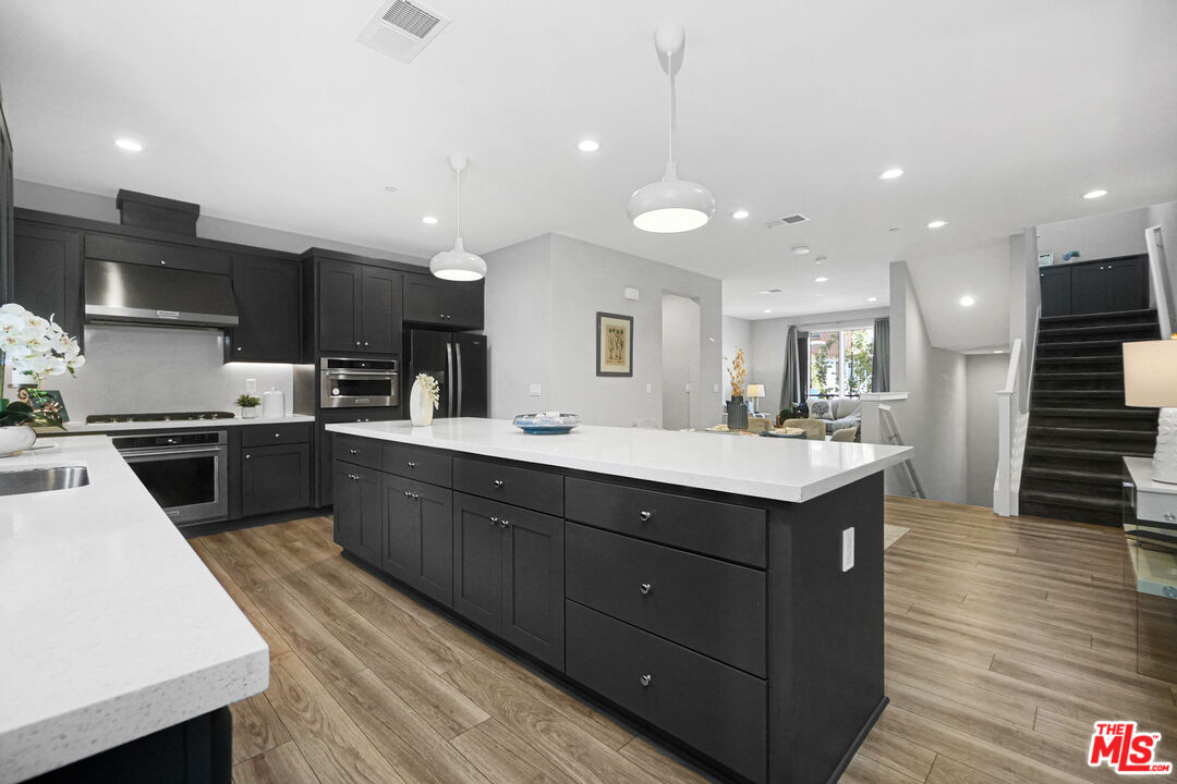 44661 Wisdom Road Fremont, CA 94538 - Photo 13 of 45 a kitchen with a sink stainless steel appliances and cabinets