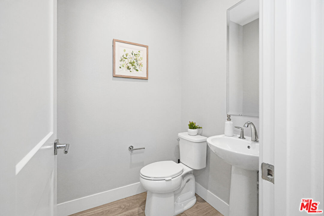 44661 Wisdom Road Fremont, CA 94538 - Photo 16 of 45 a white toilet sitting next to a bathroom sink