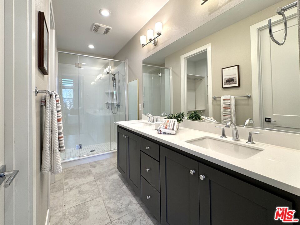 44661 Wisdom Road Fremont, CA 94538 - Photo 24 of 45 a bathroom with a shower sink double and mirror