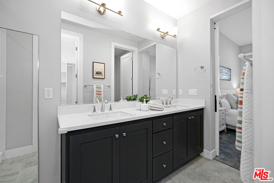 44661 Wisdom Road Fremont, CA 94538 - Photo 25 of 45 a bathroom with a double vanity sink and mirror with shower