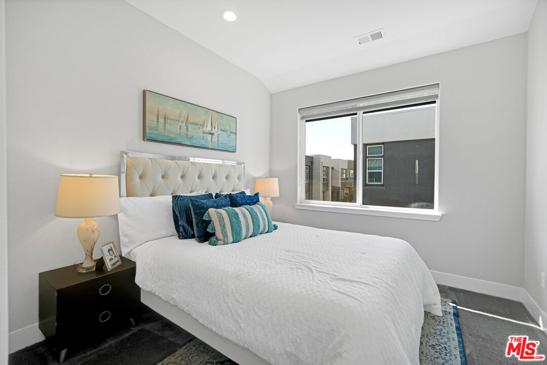 44661 Wisdom Road Fremont, CA 94538 - Photo 27 of 45 a bedroom with a bed and a lamp on dresser