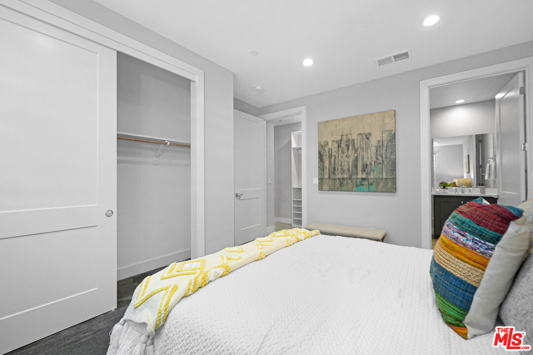 44661 Wisdom Road Fremont, CA 94538 - Photo 31 of 45 a bedroom with a bed and a painting on the wall