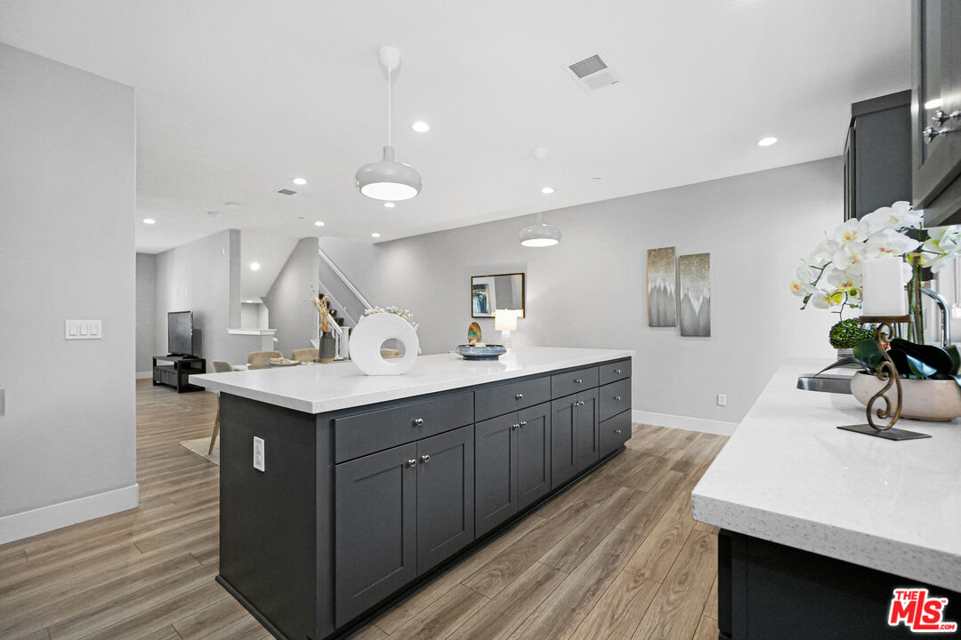 44661 Wisdom Road Fremont, CA 94538 - Photo 9 of 45 a kitchen with a sink a counter space and wooden floor