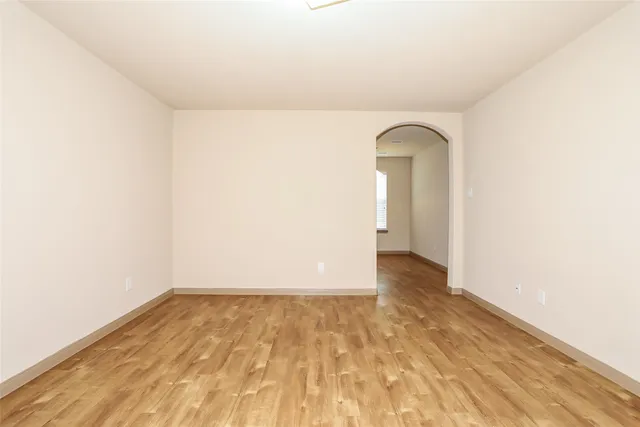 a view of a room with wooden floor
